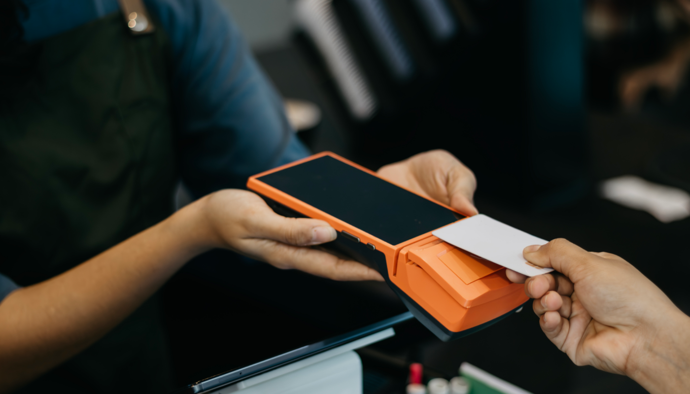 Customer tapping a card on a payment terminal
